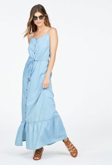a lady putting on a denim maxi gown, gladiators and sunglasses.